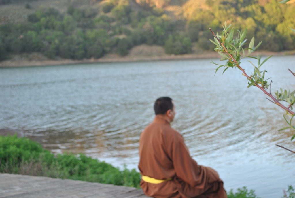 Rinpoche-sitting-in-front-water